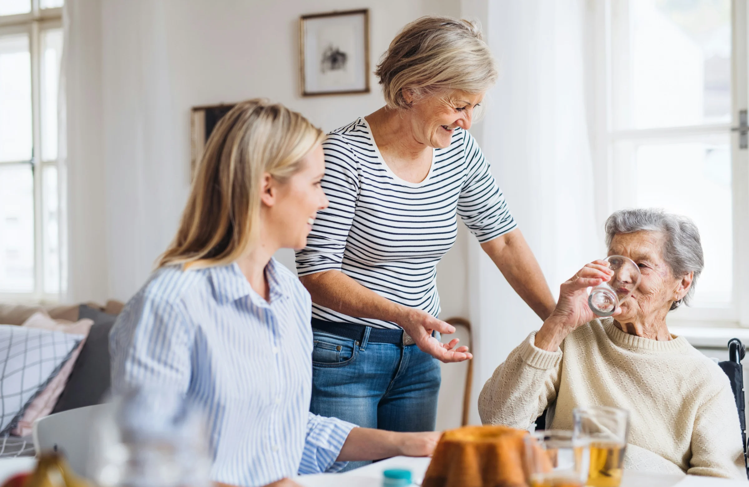 Community nurse with older client and family member at home in Brisbane