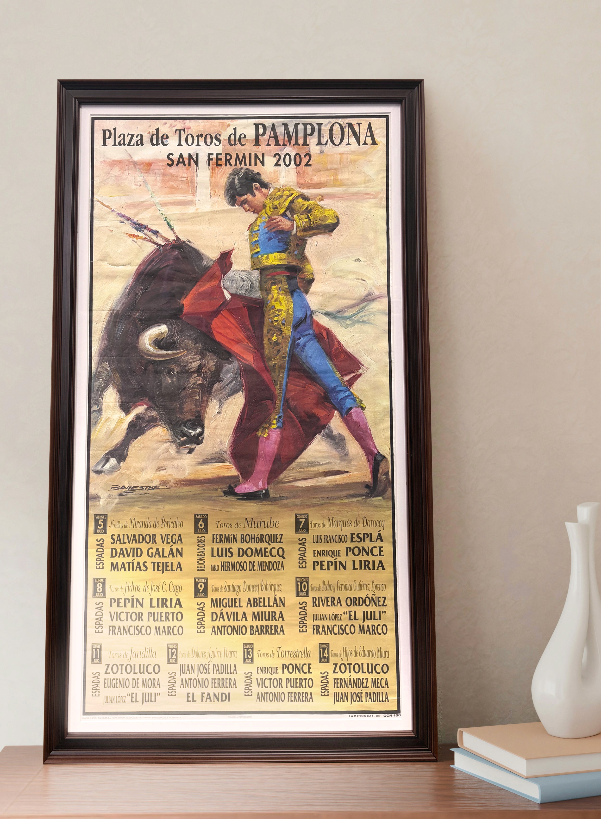 Modern indoor space with large glass doors, lush greenery, and a cozy seating area visible beyond.