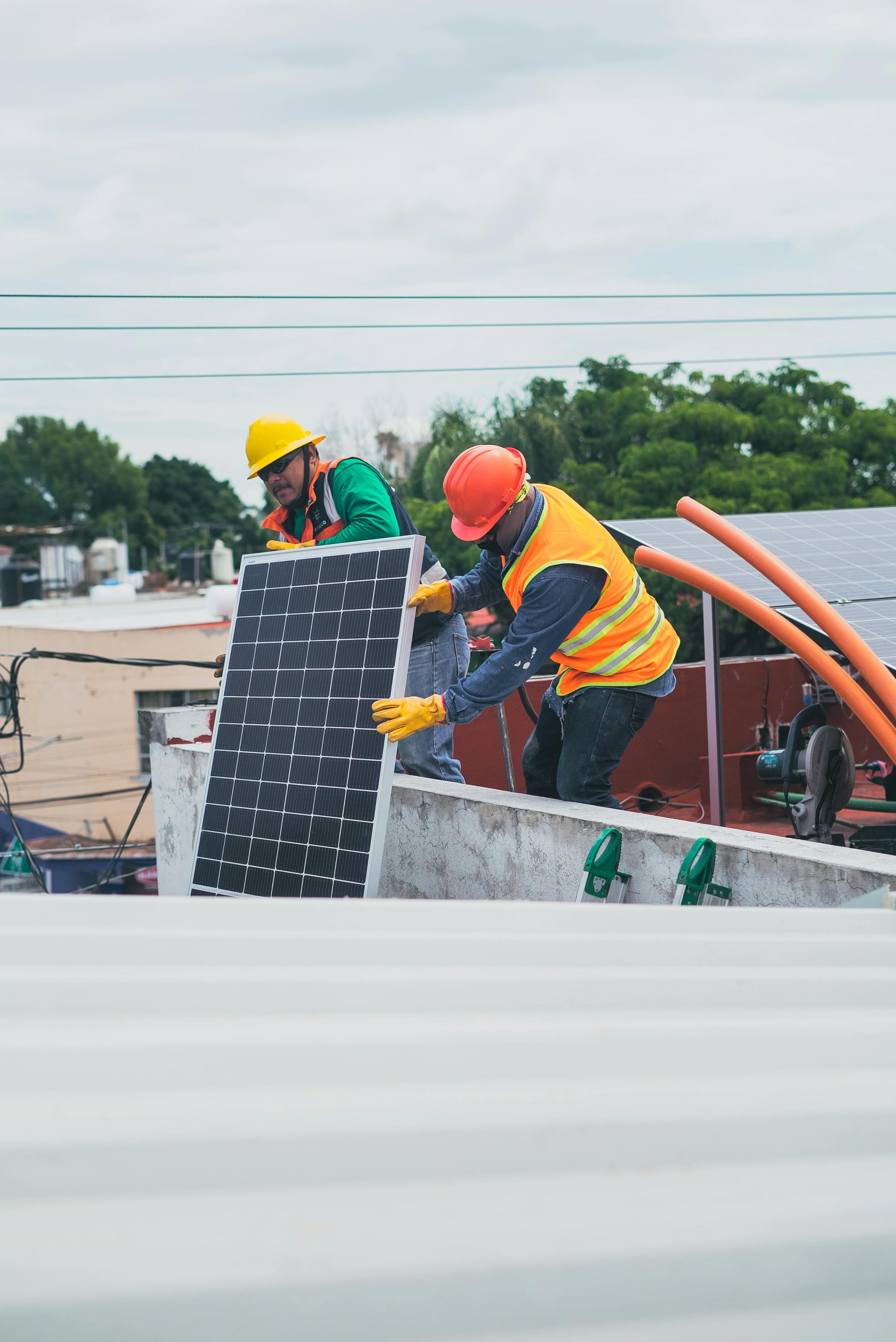 2 persons installing solar panels in a home