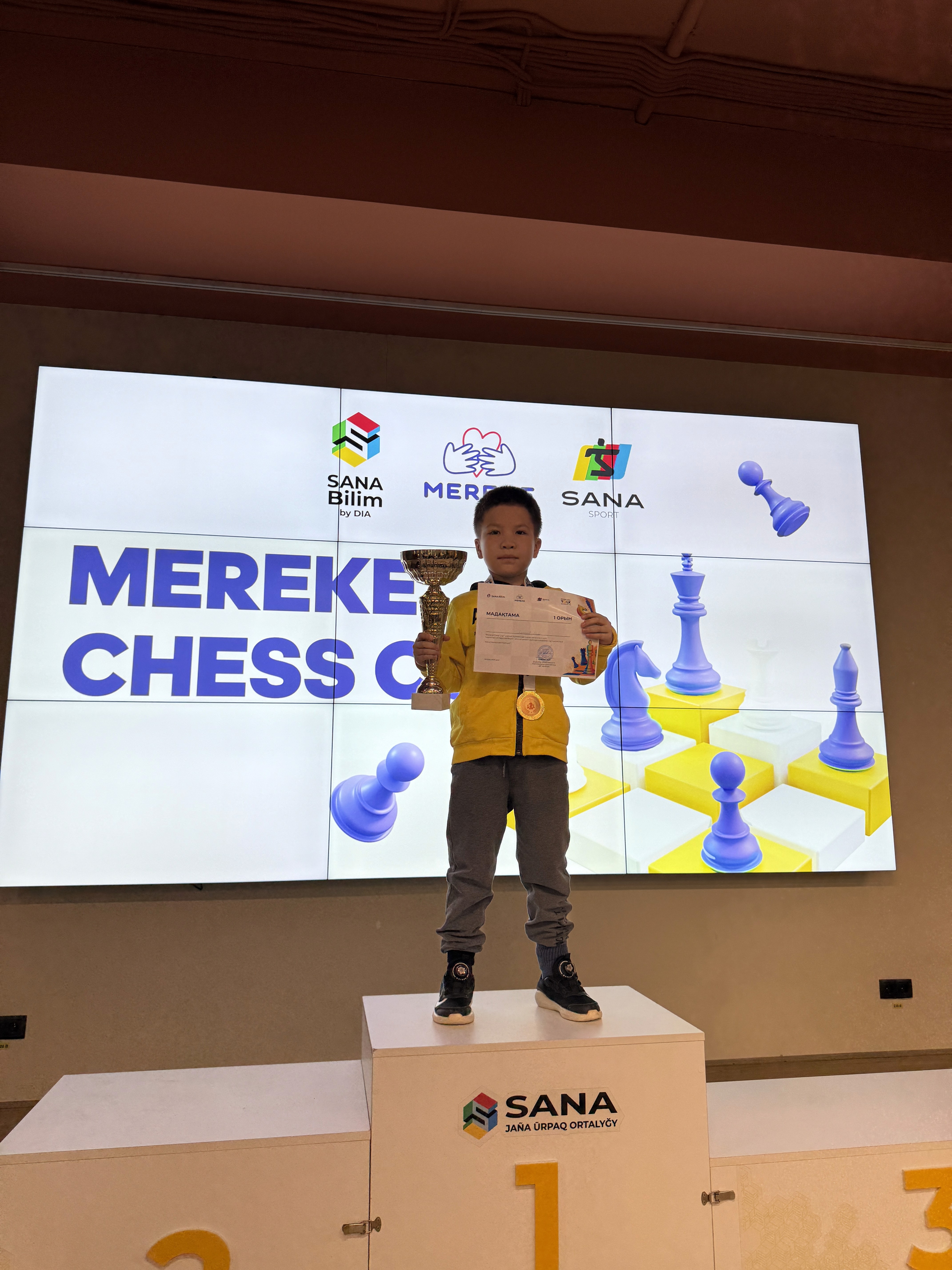 Orange and gray knitted beanie floating over a soft blue background.