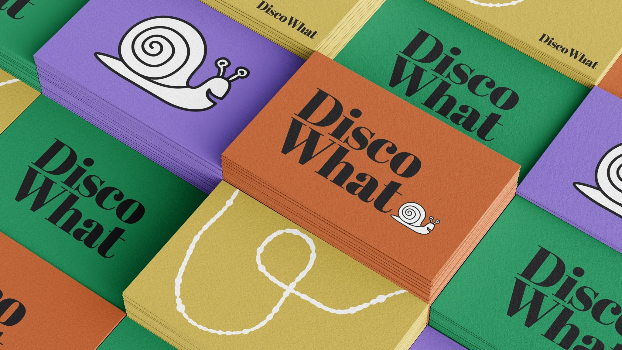 Stacks of business cards with Disco What logos printed on them.