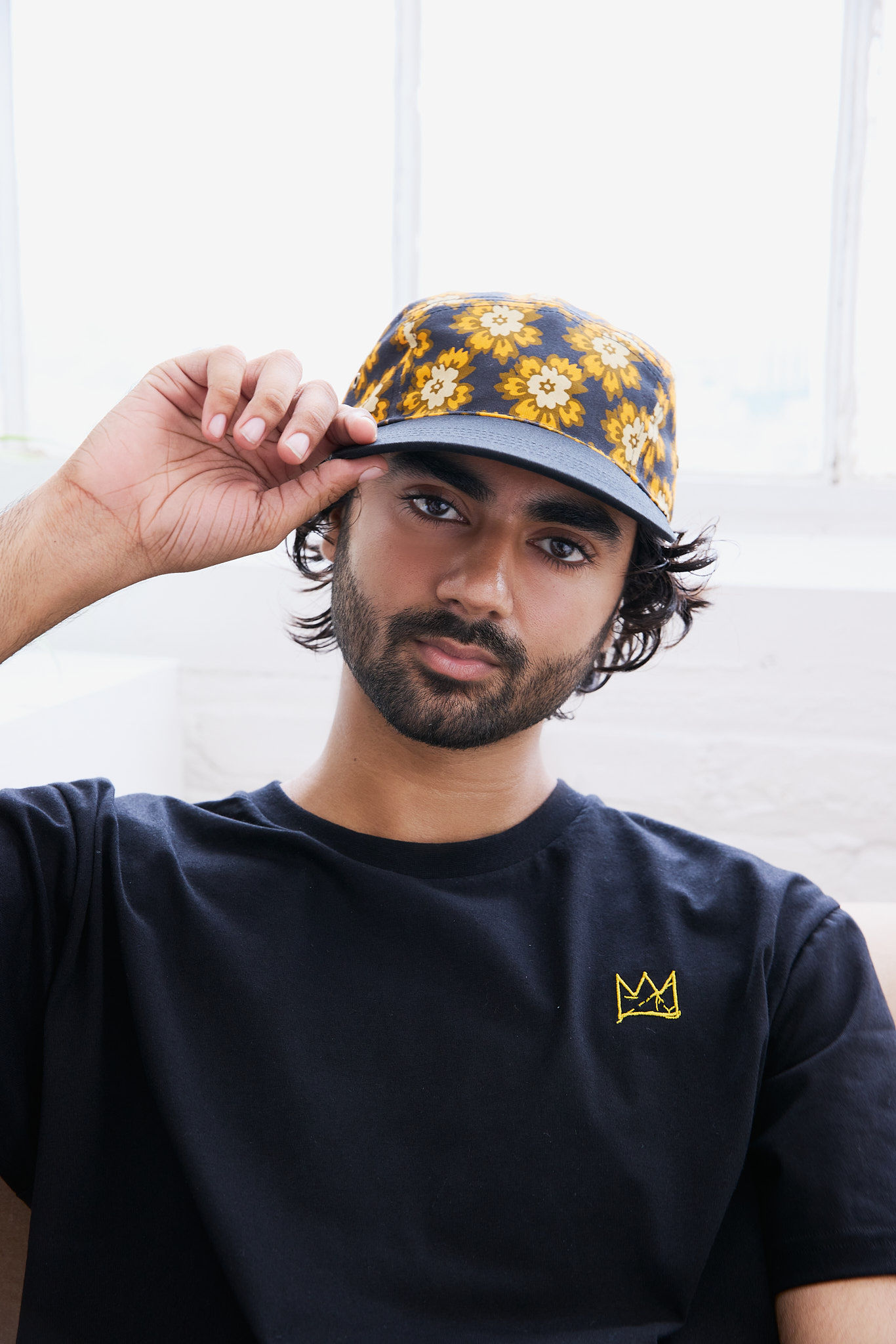 Young woman with dark hair and bangs, wearing red.
