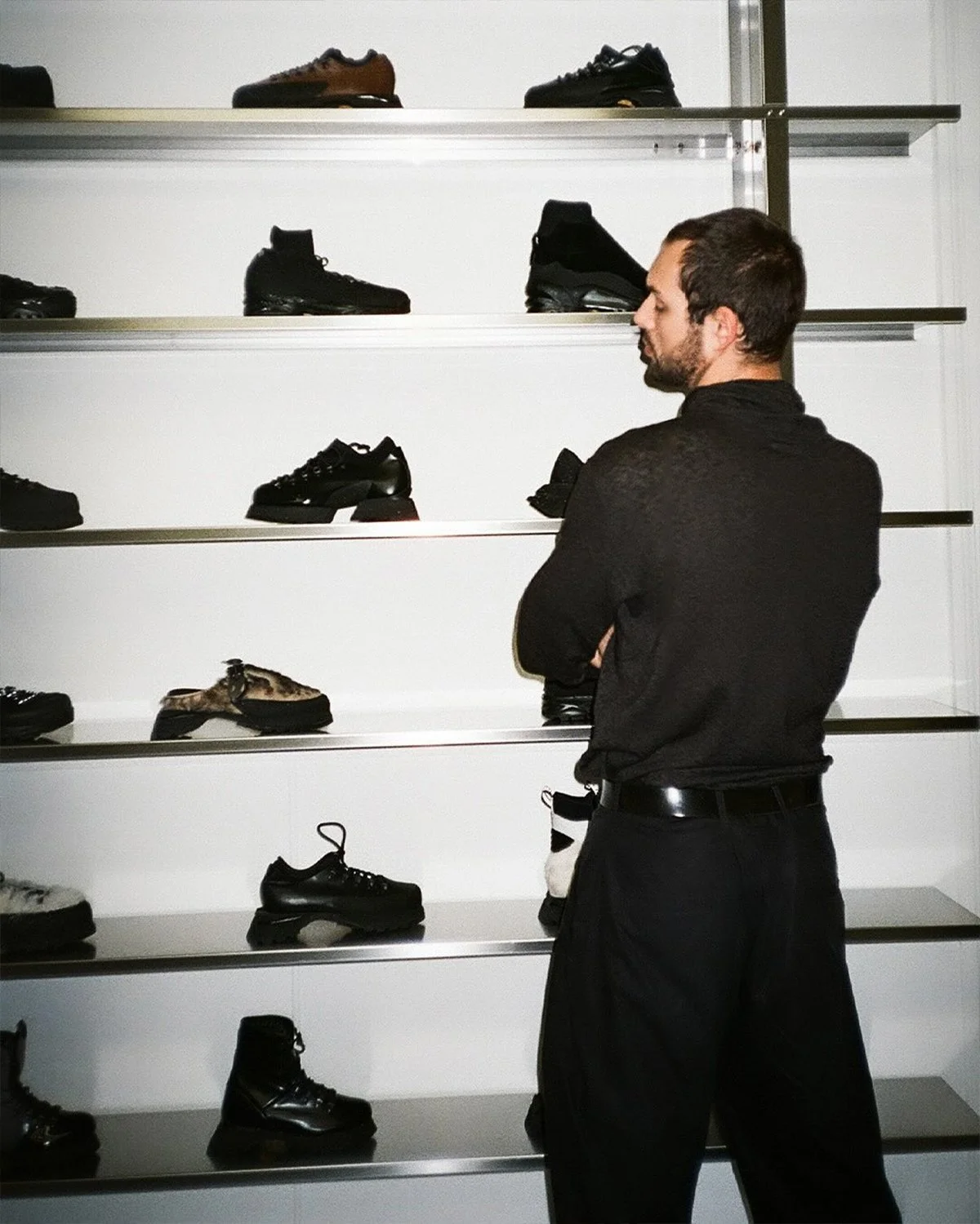 A fluffy gray rabbit rests on a floral chair.