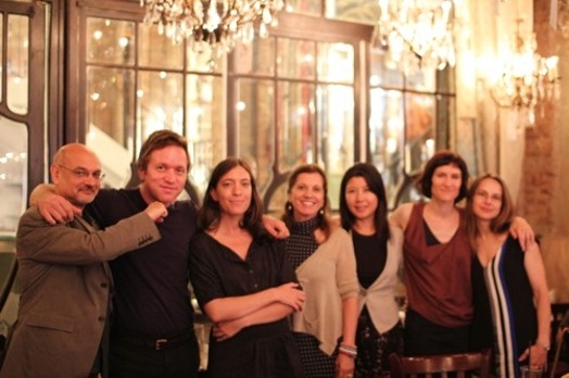 group photo of seven people in a restaurant