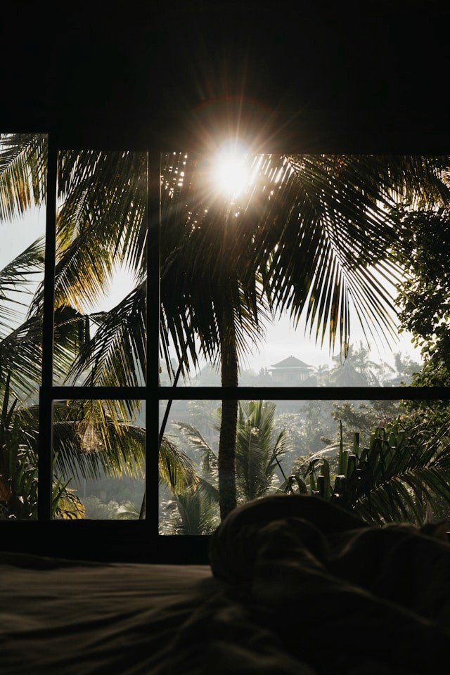 A woman receives a relaxing energy healing in a serene setting with soft lighting.