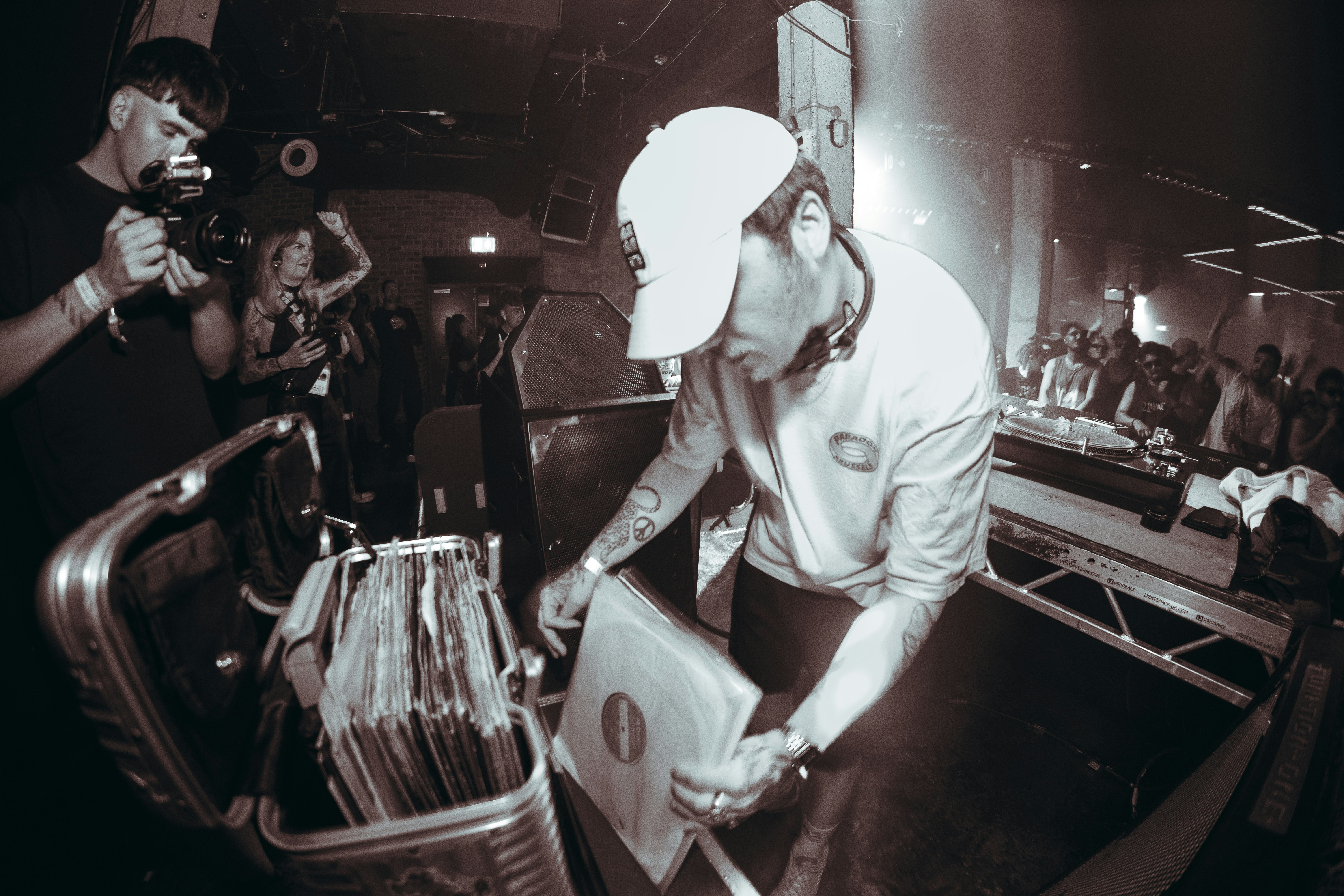 Man rifling through records behind a DJ set