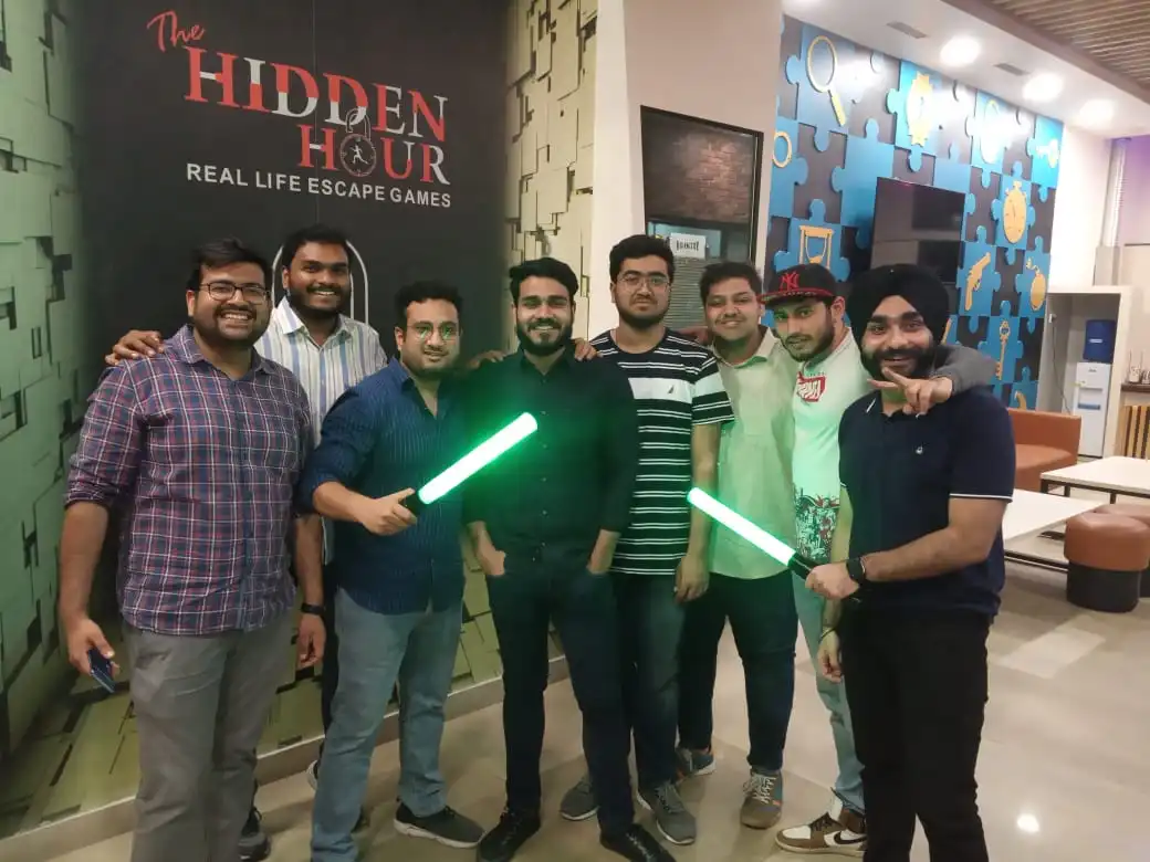 Group of colleagues solving puzzles together during a team building event in Delhi