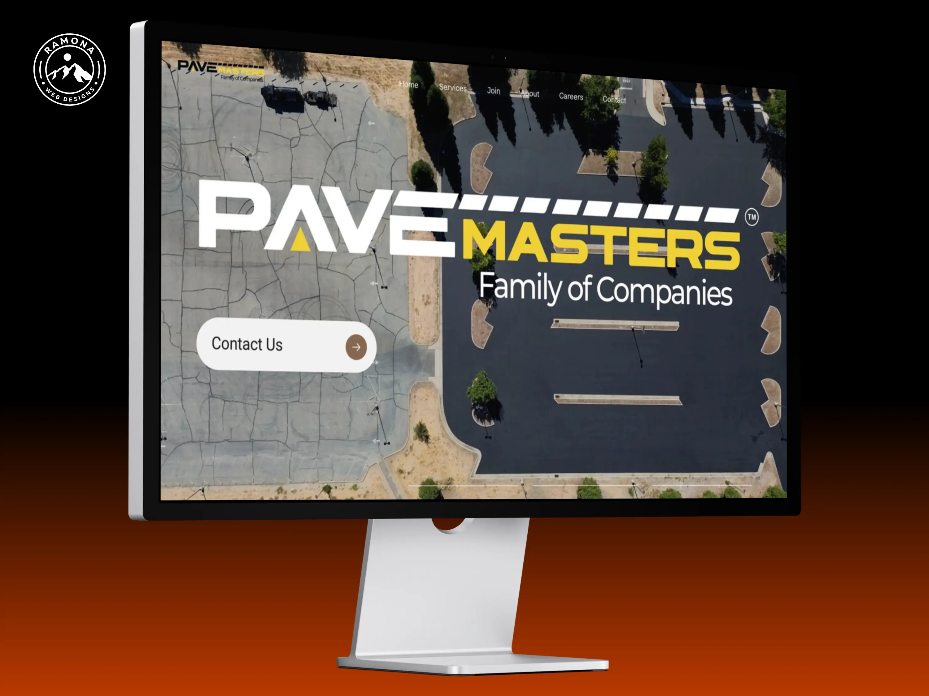 Desktop computer showing PaveMasters website homepage