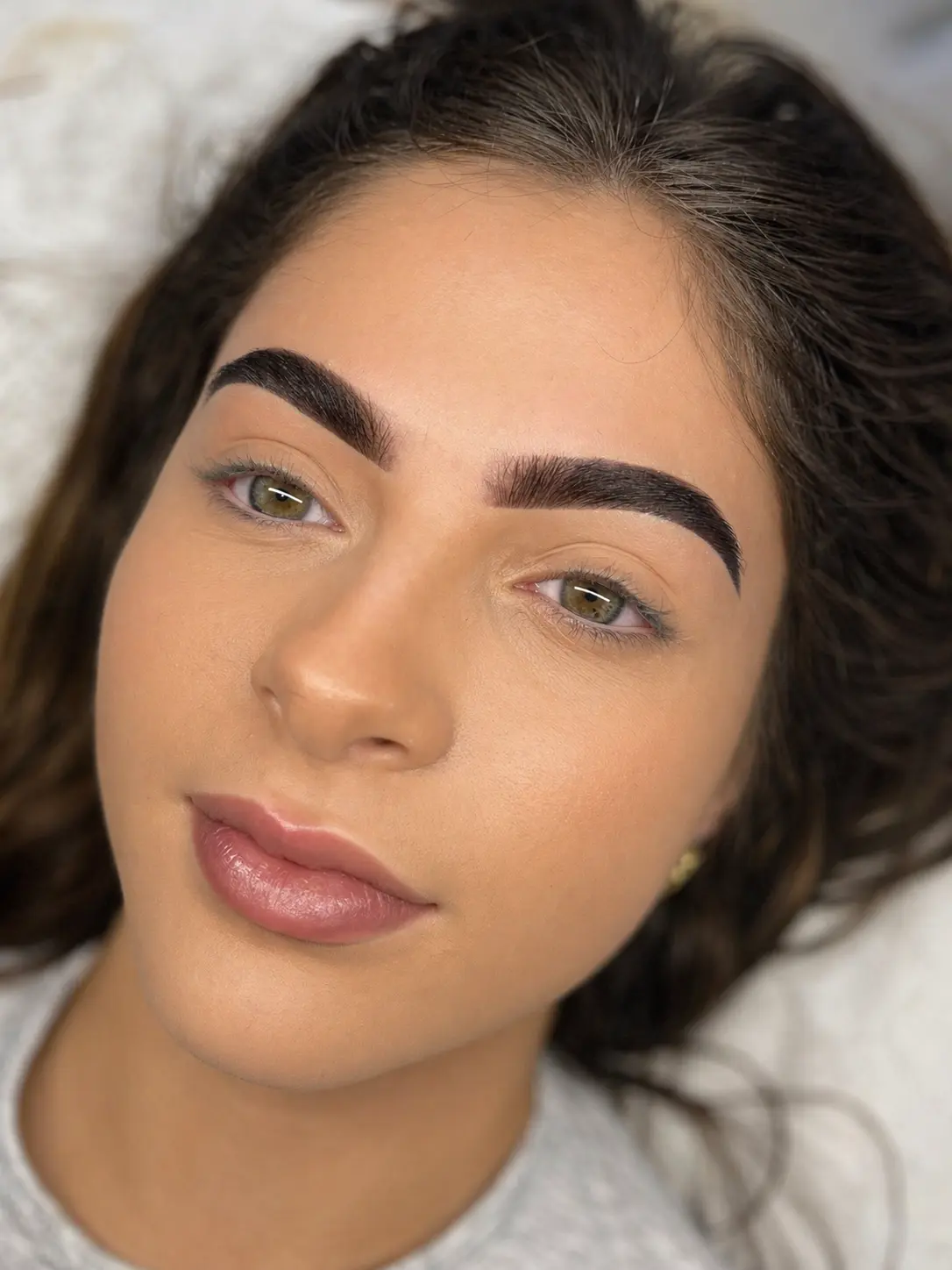Client showing natural signature brow shaping and tinting results at Mali Beauty Eastbourne