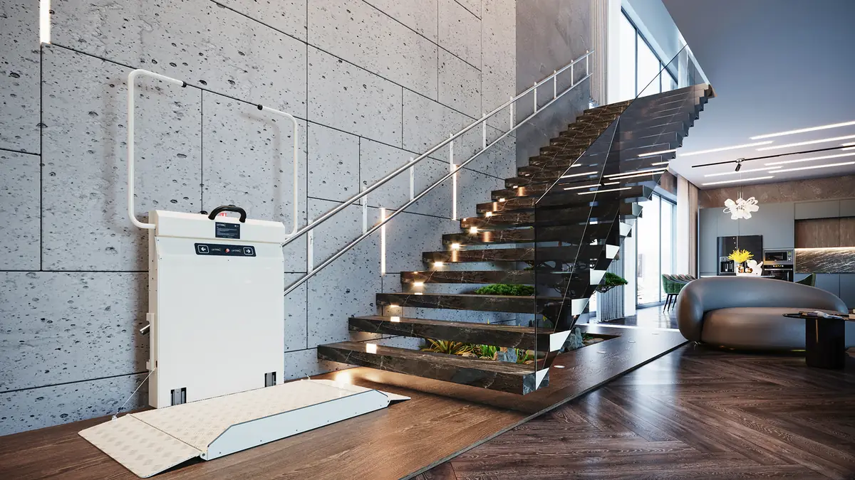 Liftak incline platform stairlift fitted to a wall-mounted rail beside a contemporary glass and marble staircase in a modern open-plan home