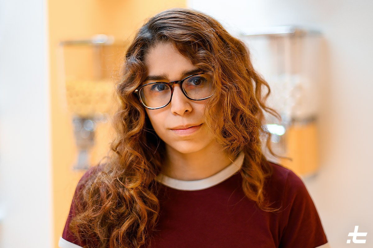 A young girl wearing glasses smiling. emitela