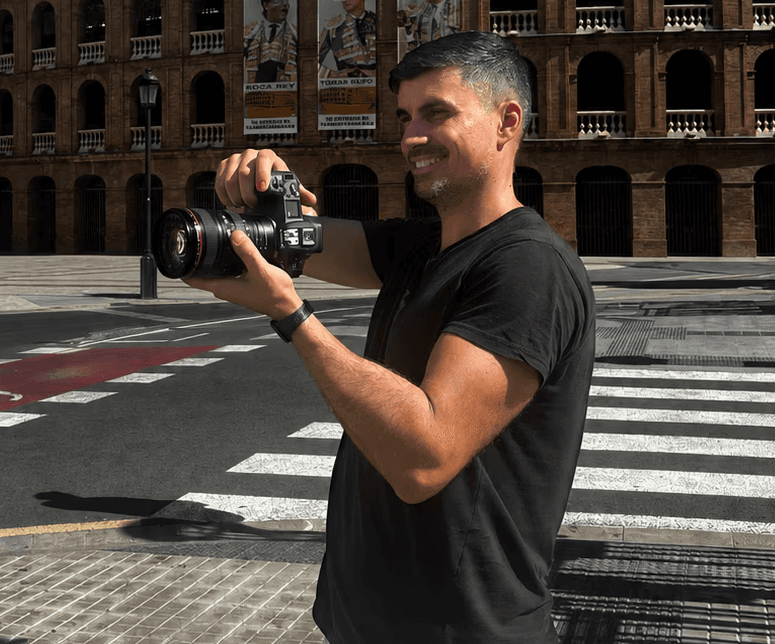 a videographer man curious pavel adjusting his camera during a client photo shoot