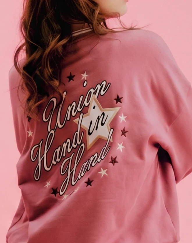 Back of a mauve sweatshirt featuring a star graphic and the words “Union Hand in Hand.”