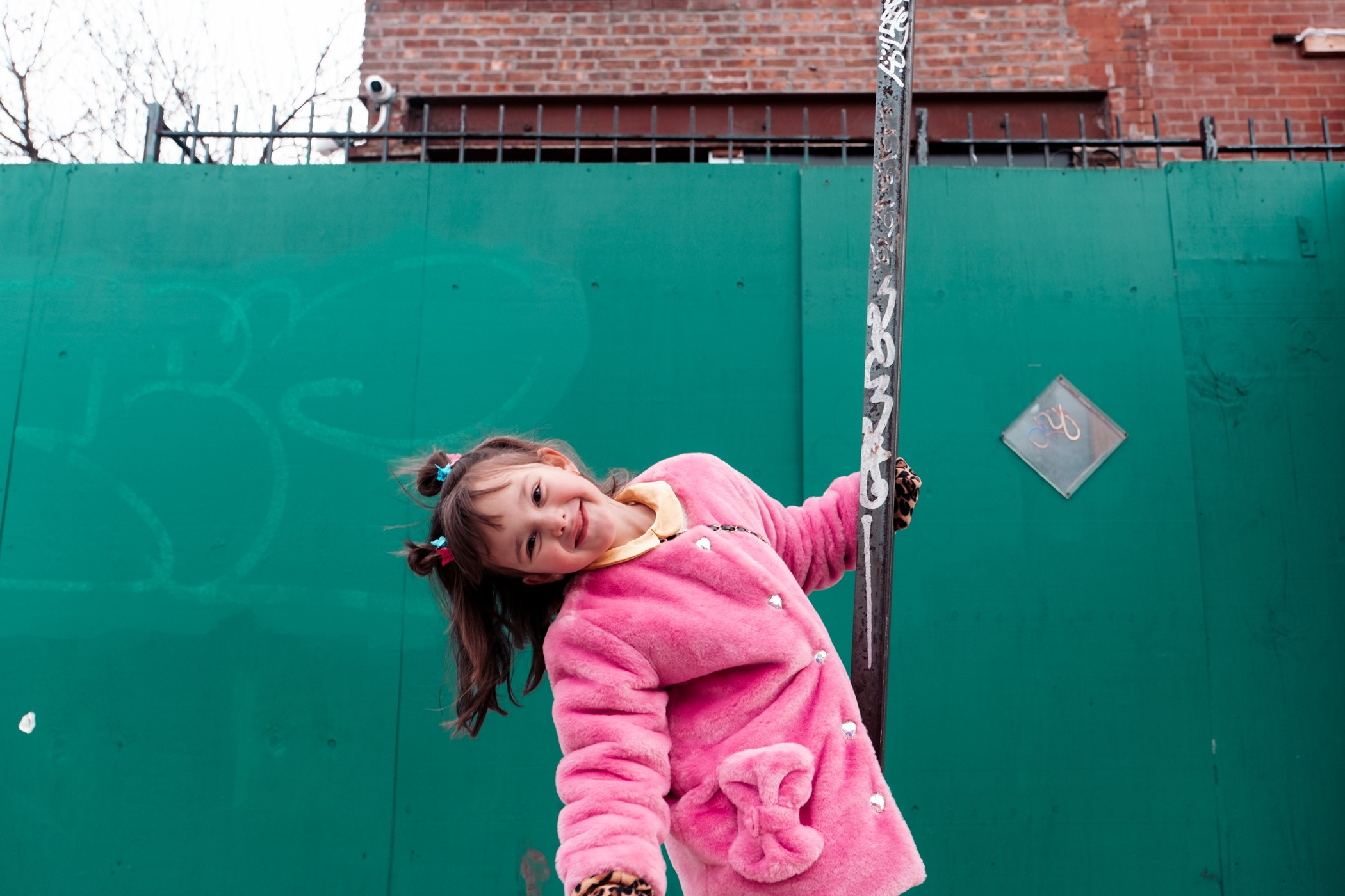 katt-jones-photography-happy-young-girl-portrait-pink-fur-coat-nyc