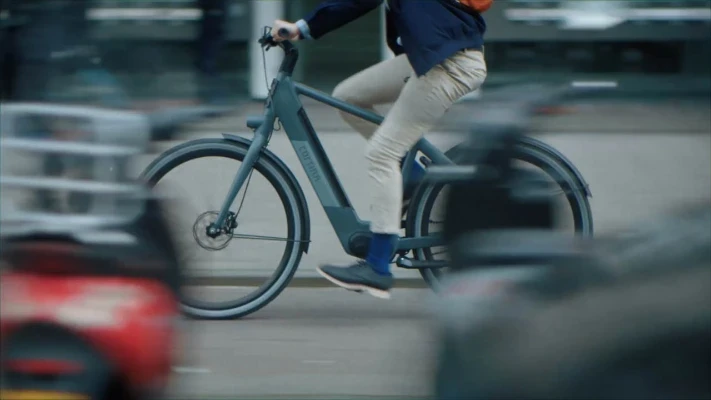 A biker cycling across Amsterdam