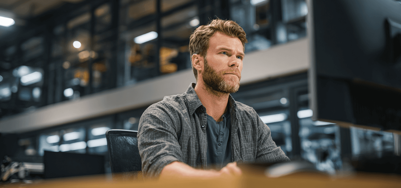man in black long sleeve shirt using macbook