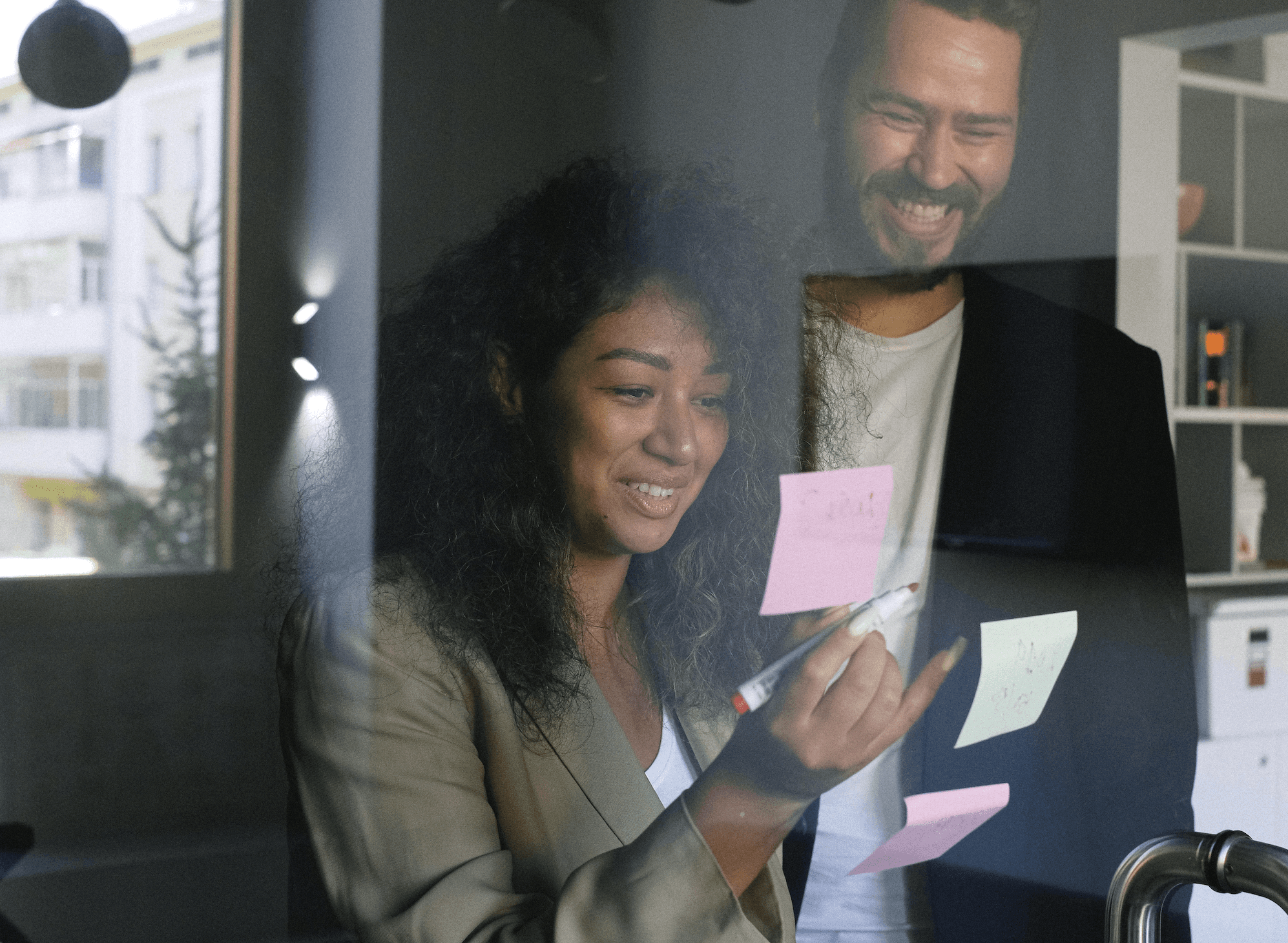 a woman smiling with a tablet computer