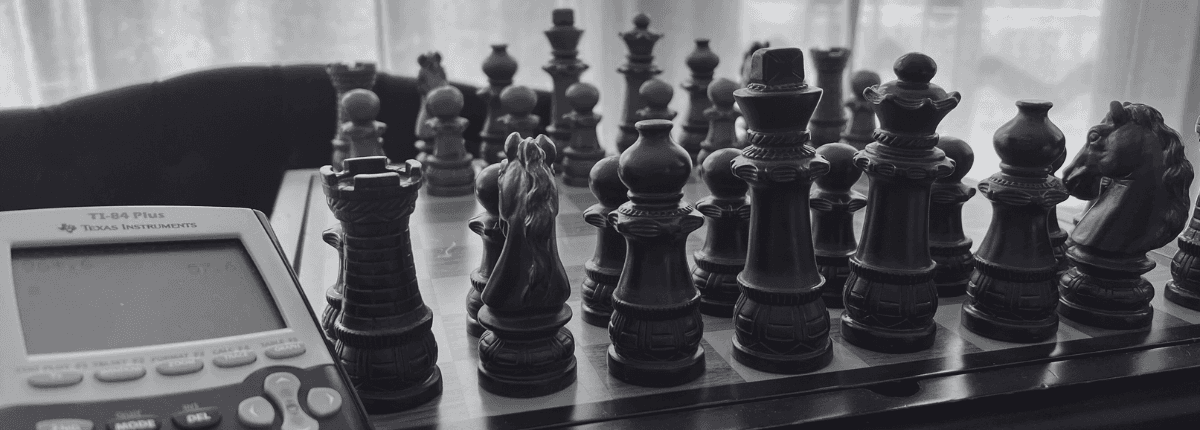 Close-up of a chessboard and a math calculator