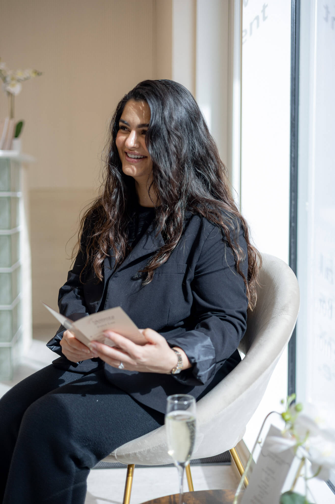 Client relaxing in waiting area inside modern aesthetic and laser clinic.