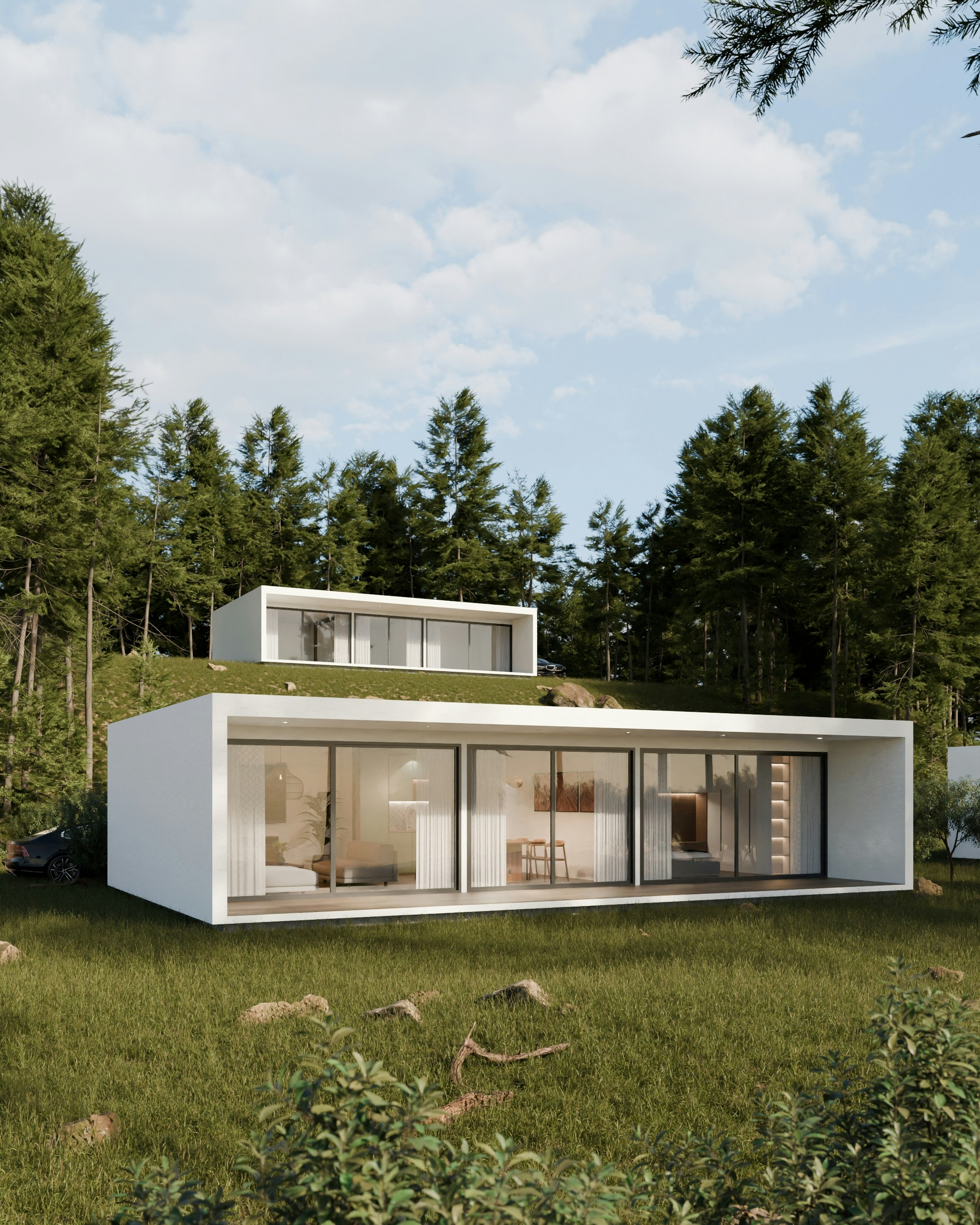 Modern houses nestled in a lush green forest setting.