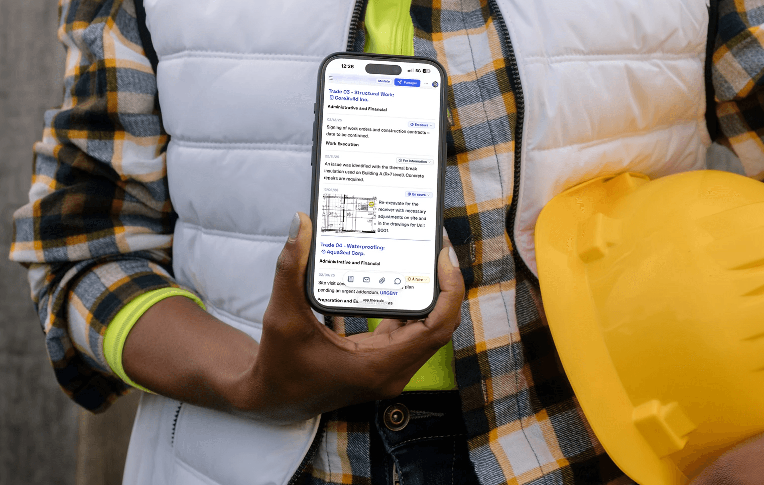 A woman on site handing her phone with a report in there