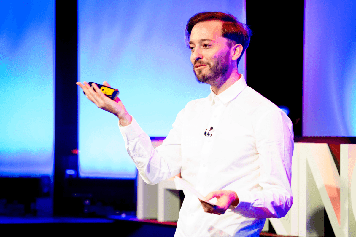 A man doing a speech on stage