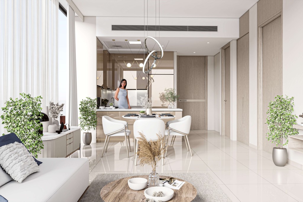 A woman stands in a modern kitchen at Arib Boutique in DubaiLand, showcasing contemporary design and appliances.