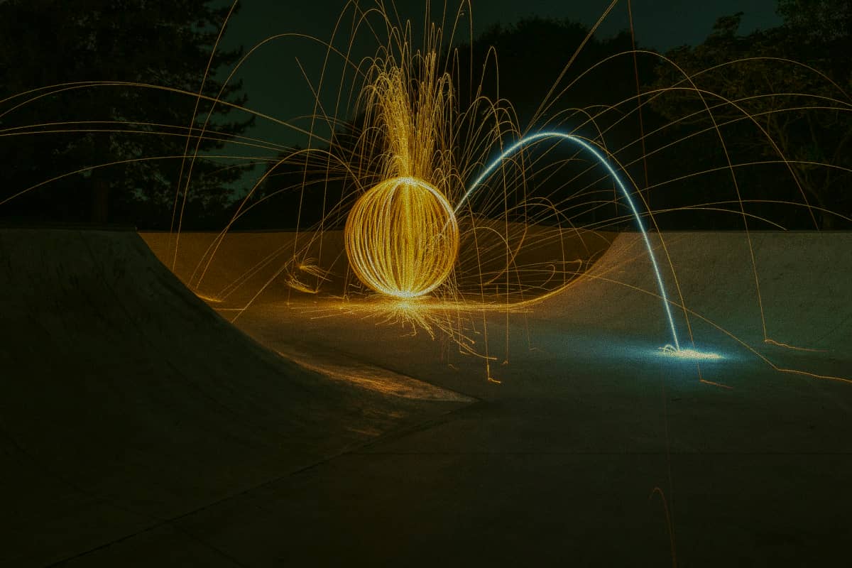 man in the dark surrounded by circular light trails