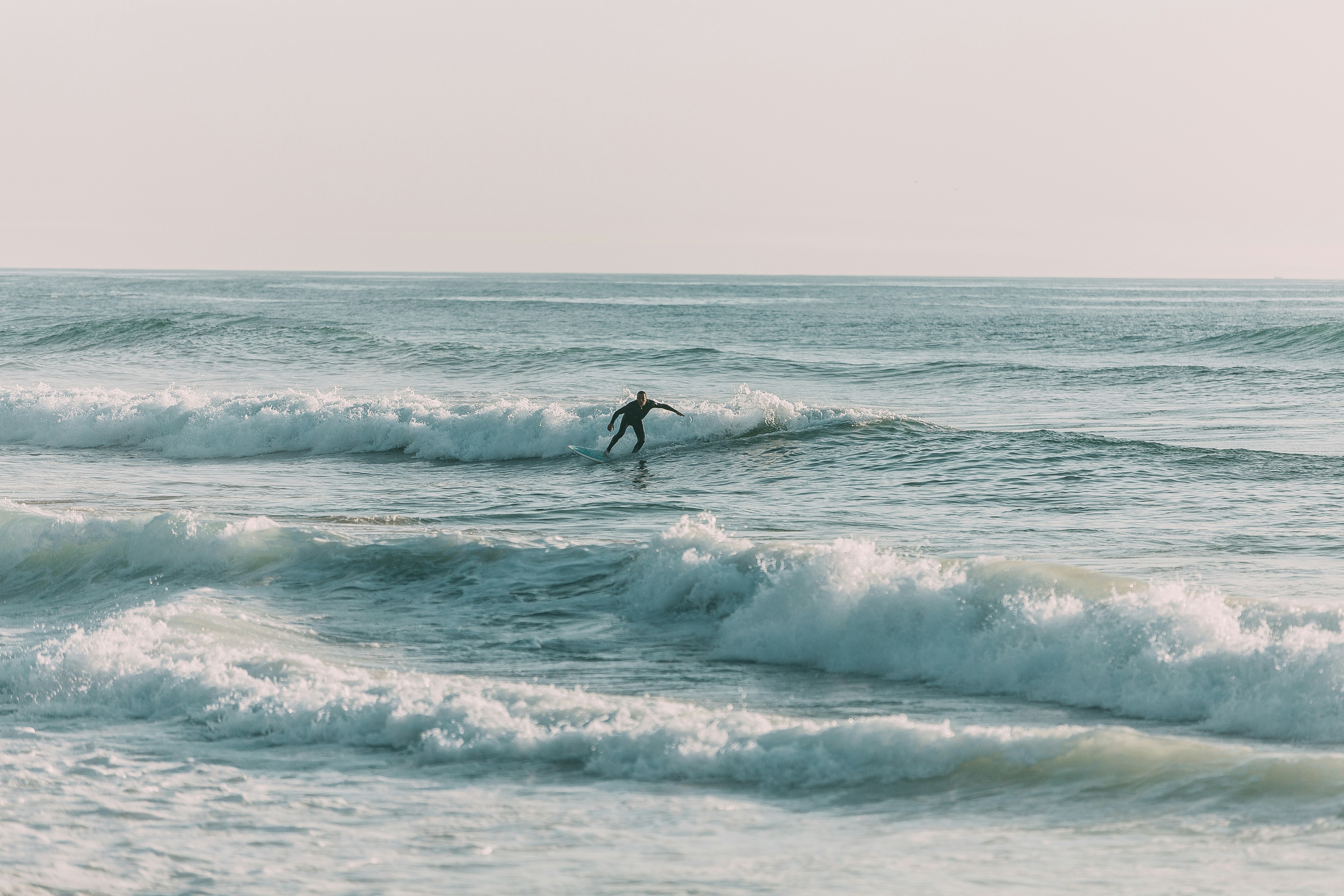 Surfer carving through a wave on the open sea.