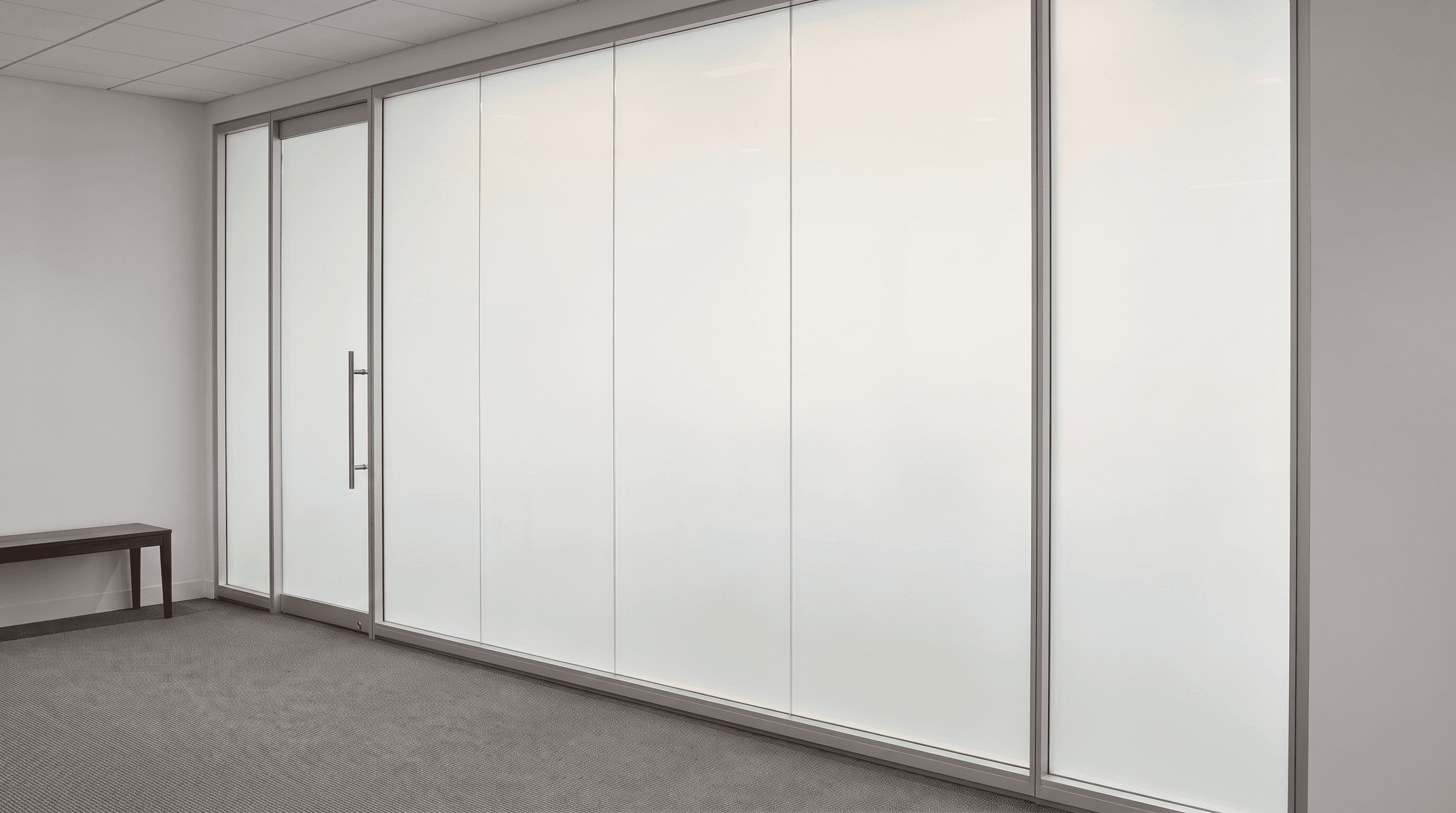 Switchable smart glass partition in frosted privacy mode — instant opaque glass wall for private meetings and conference rooms.