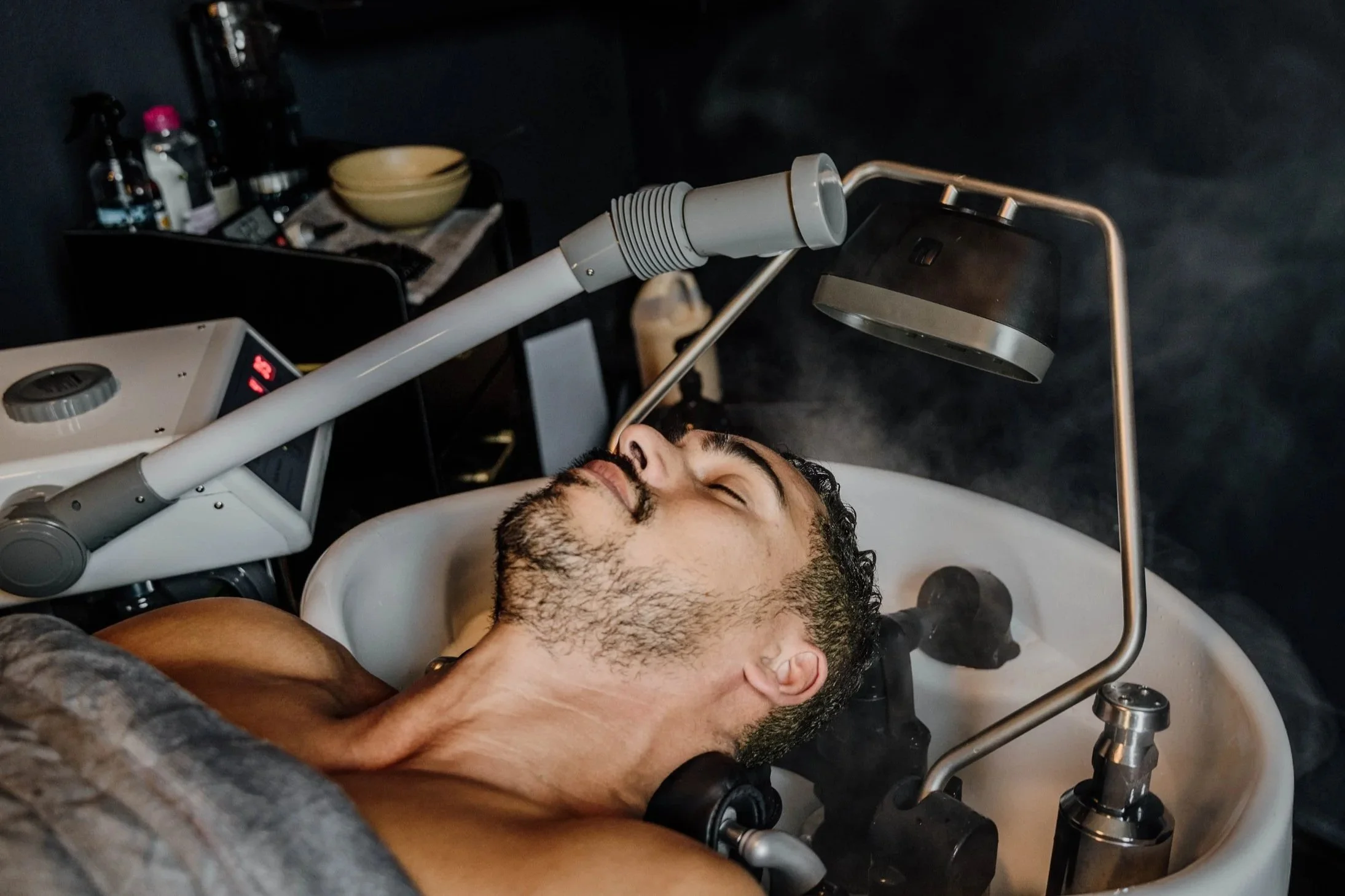 Man in head spa chair receiving treatment