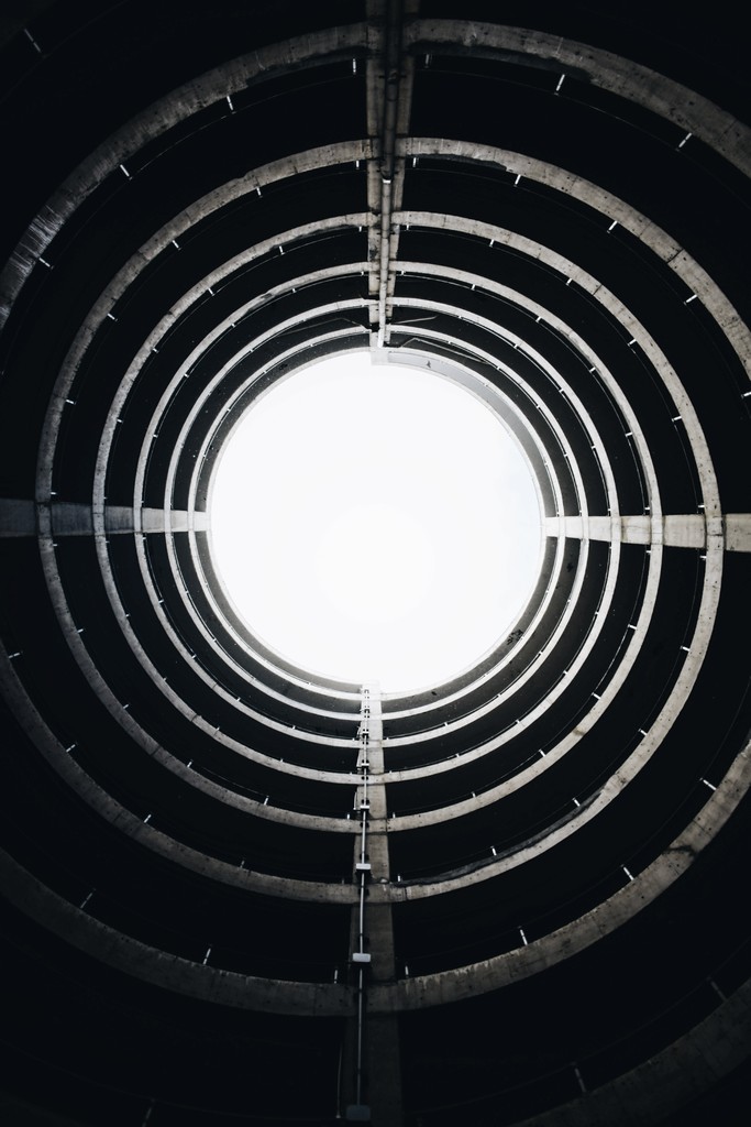 abstract image showing the above sky shot from the ground inside a round building.