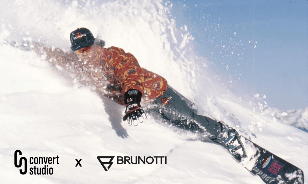 Hero image with a snowboarder carving down the mountain