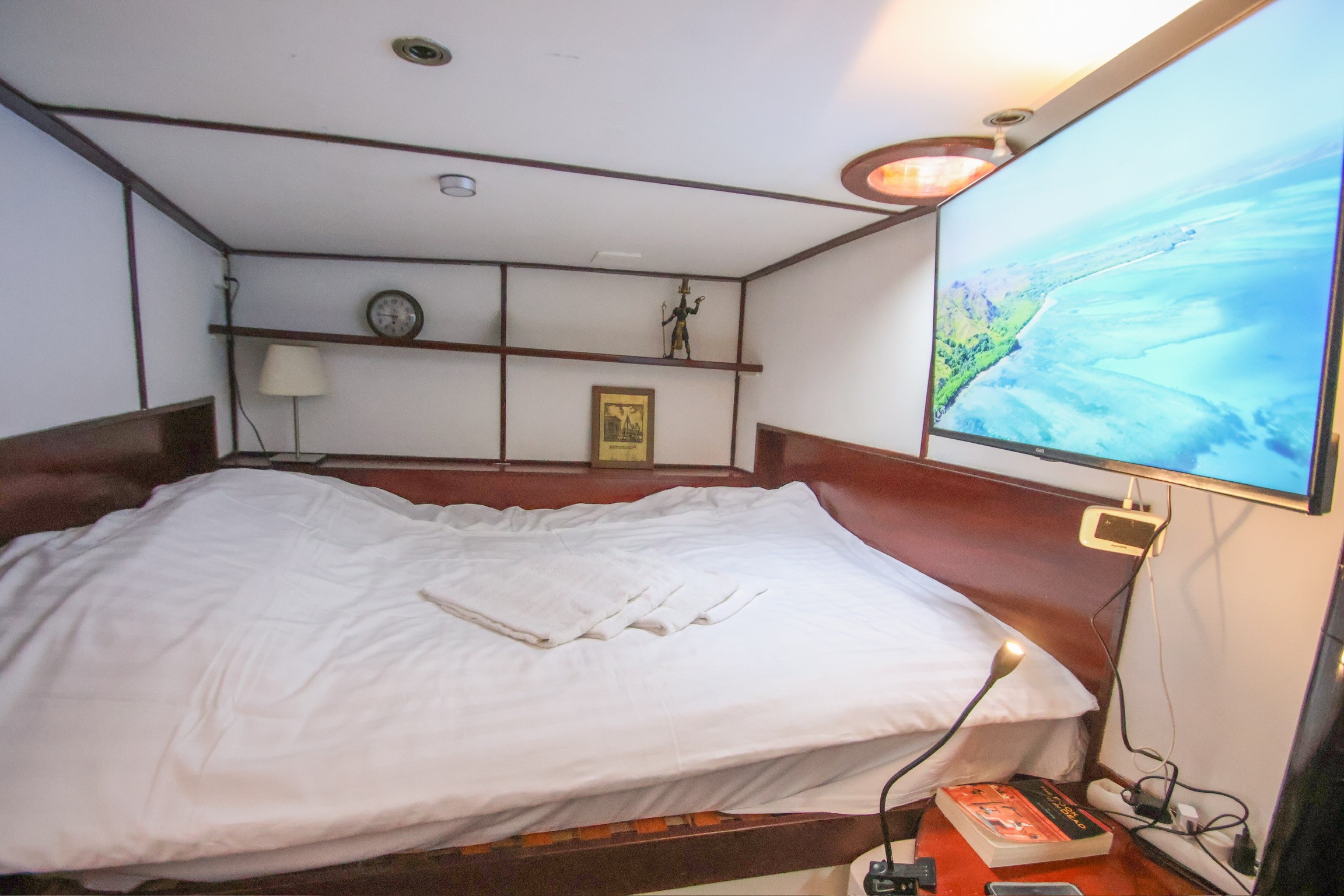 Gray sectional sofa with black coffee table and blue rug