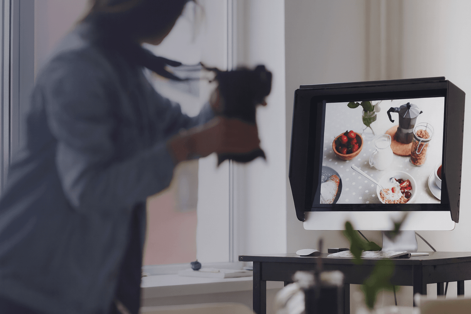 A photographer captures food items displayed on a computer screen, showcasing how product videos can enhance e-commerce product pages