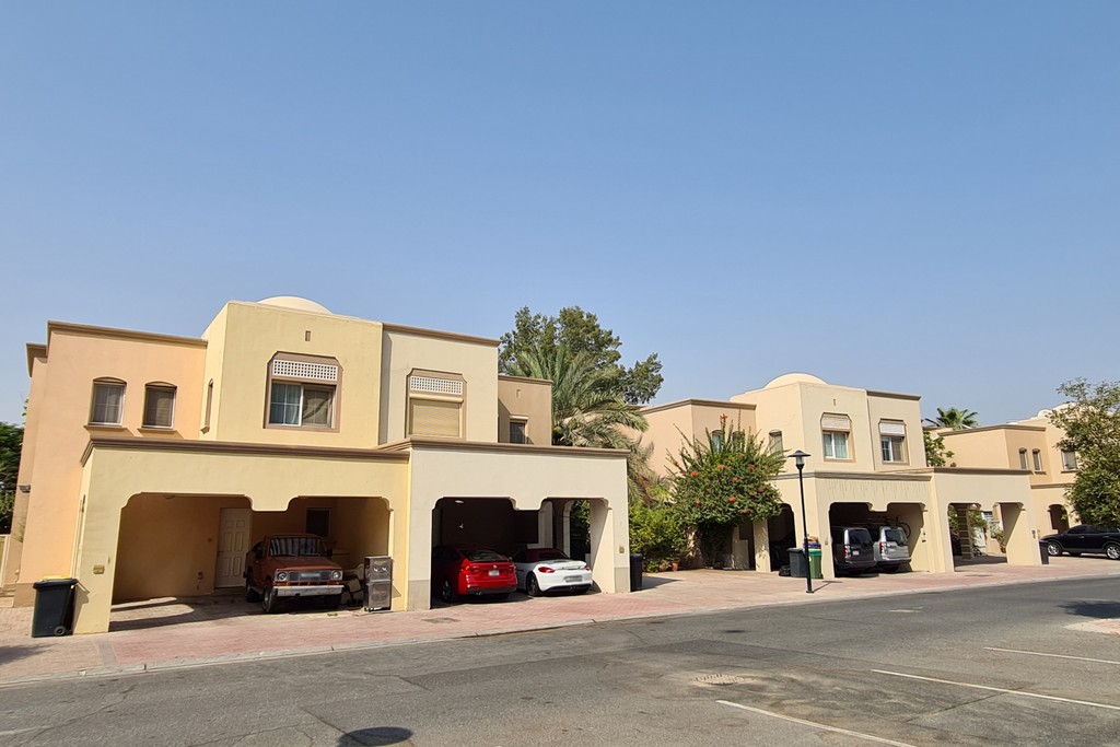 A row of houses lining a street in the Springs 11 area, showcasing a suburban neighborhood setting.