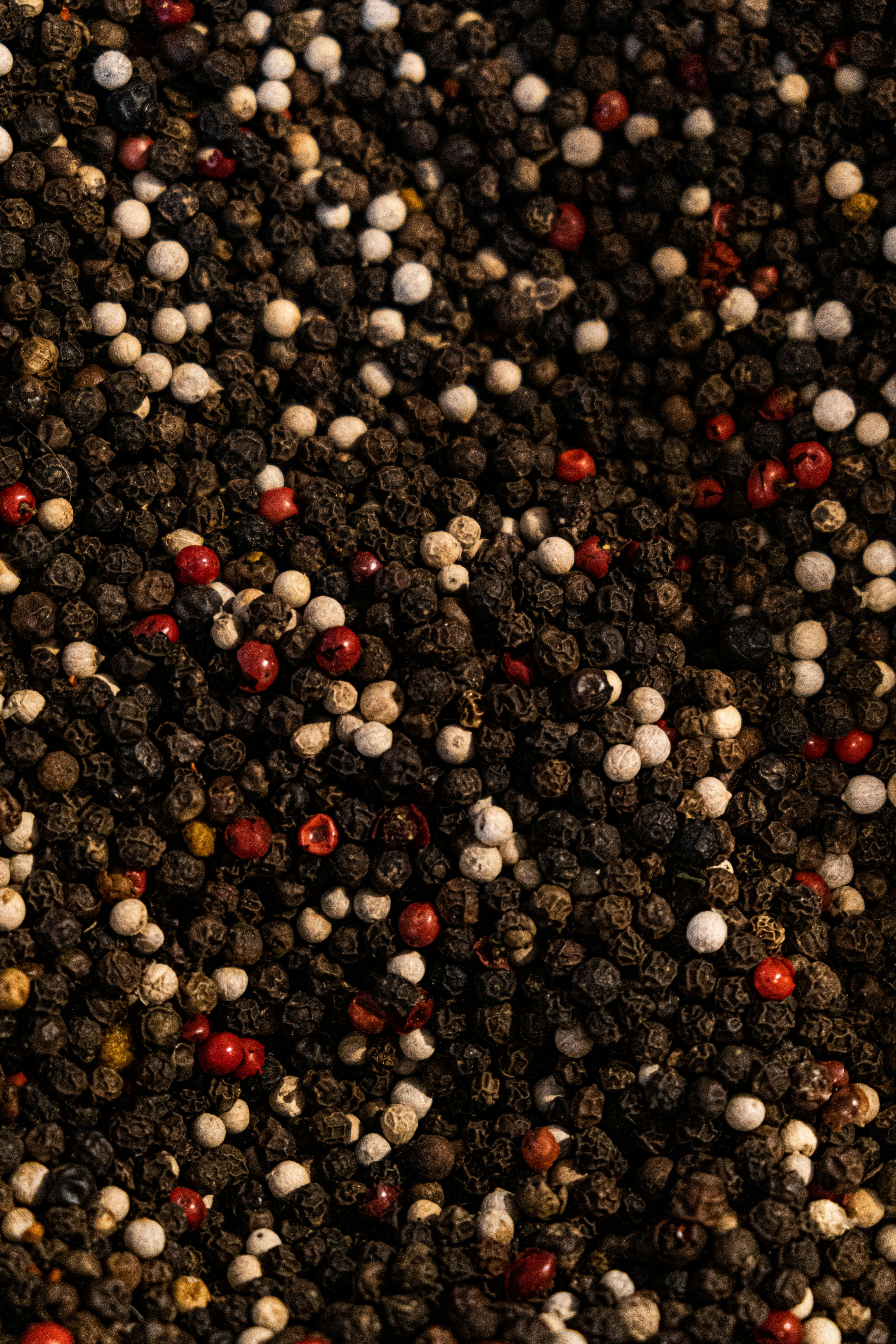 a close up of a pile of red and white pepper