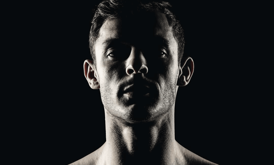 Dramatic portrait of Danilo Dash Creati with strong shadows and studio lighting.