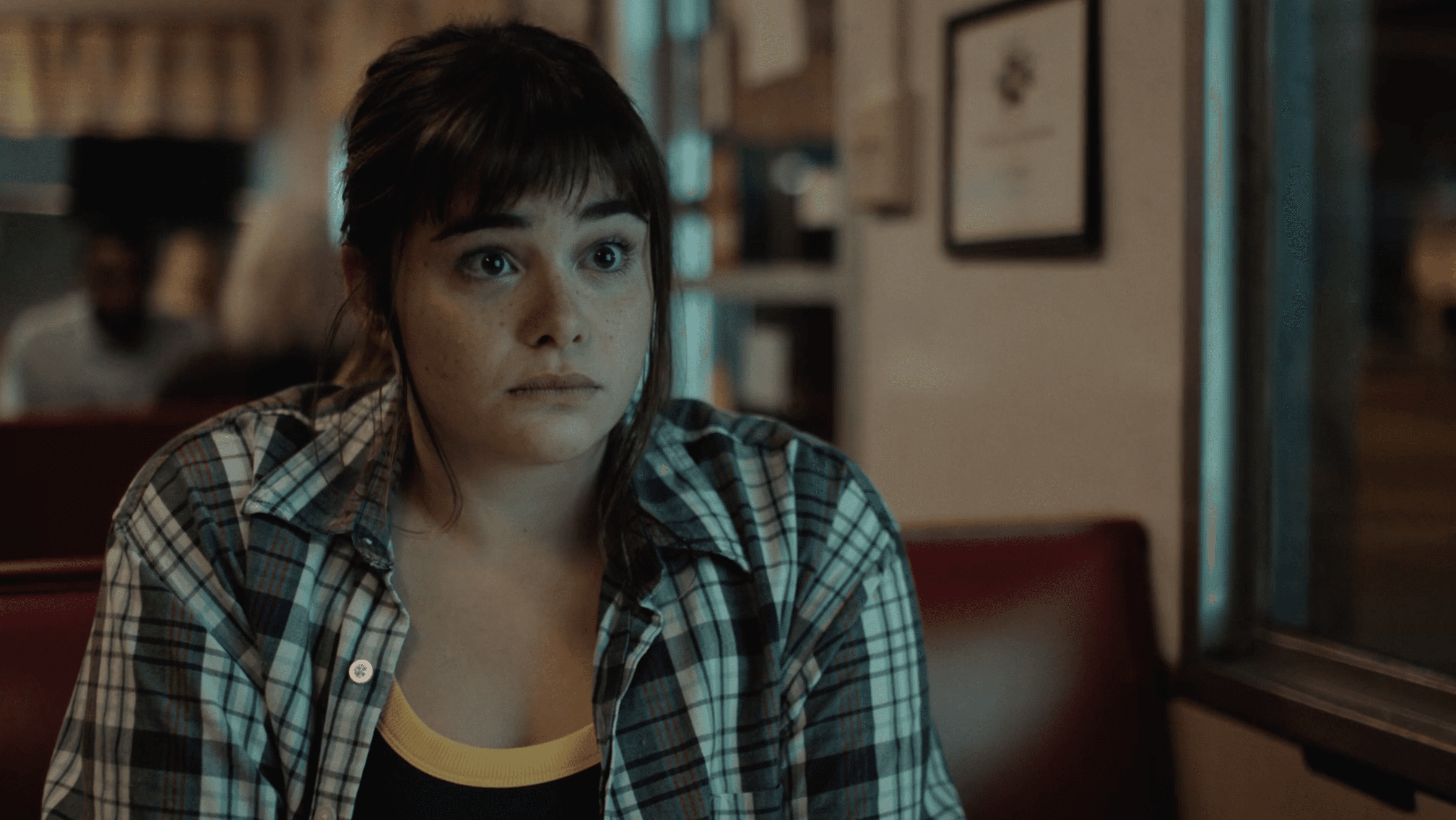 Vintage office with a typewriter, wooden desk, and green leather chair.