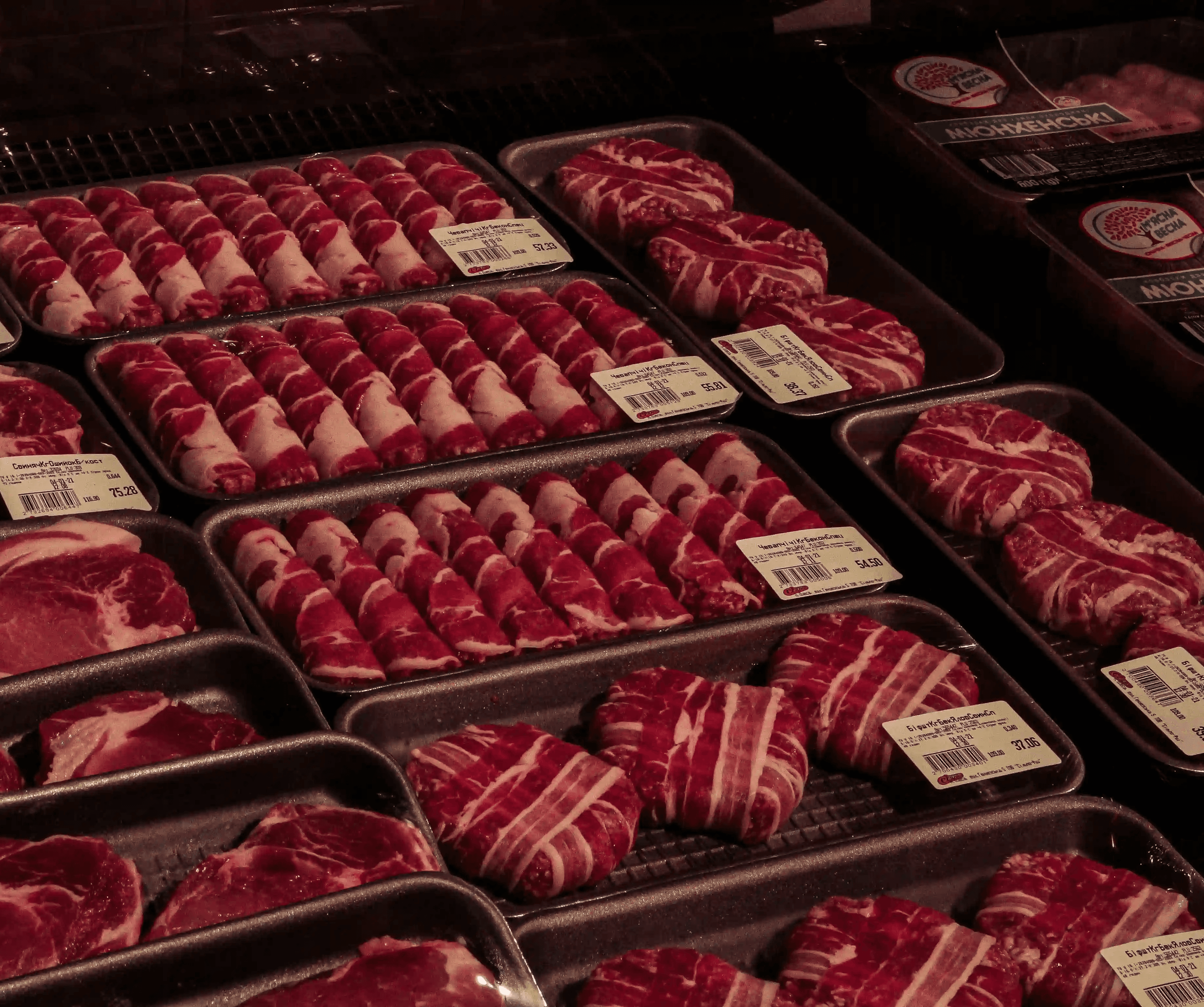 man in white dress shirt and black necktie holding raw meat