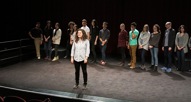 people at theater with woman in front