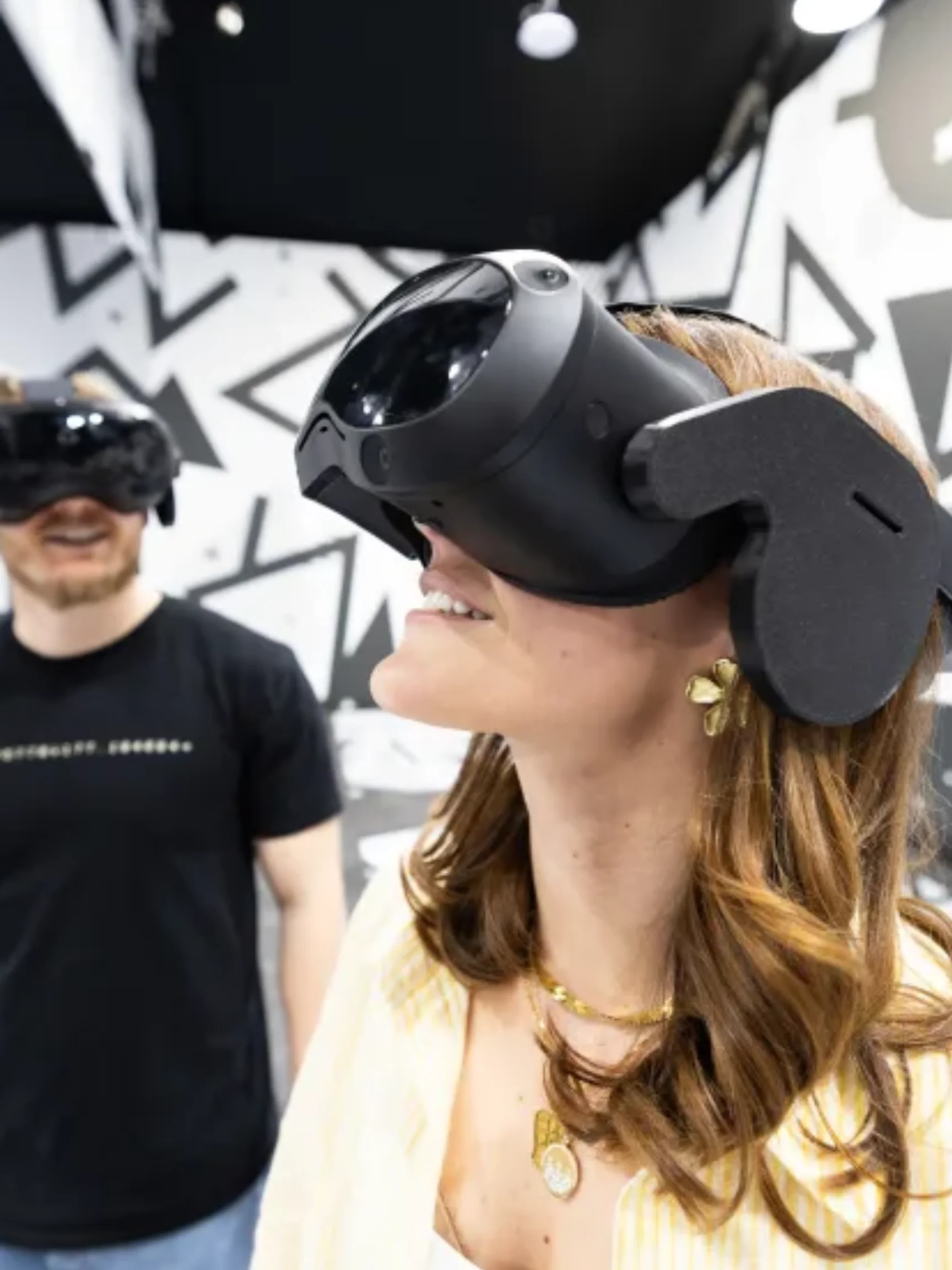 Two people wearing VR headsets during the Titanic: A Voyage Through Time immersive experience at the Shops at Rivercenter