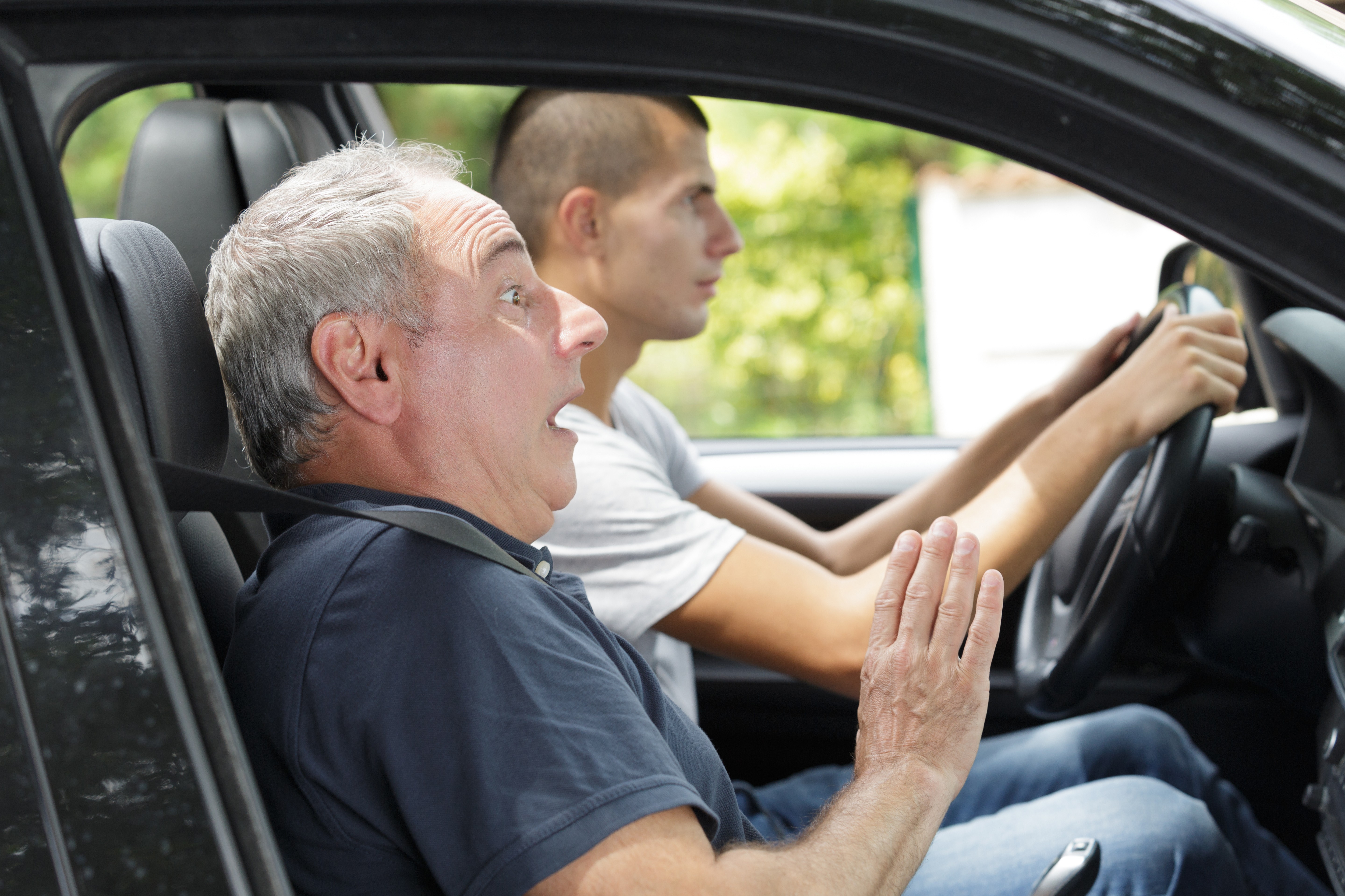 man driving with son, scared