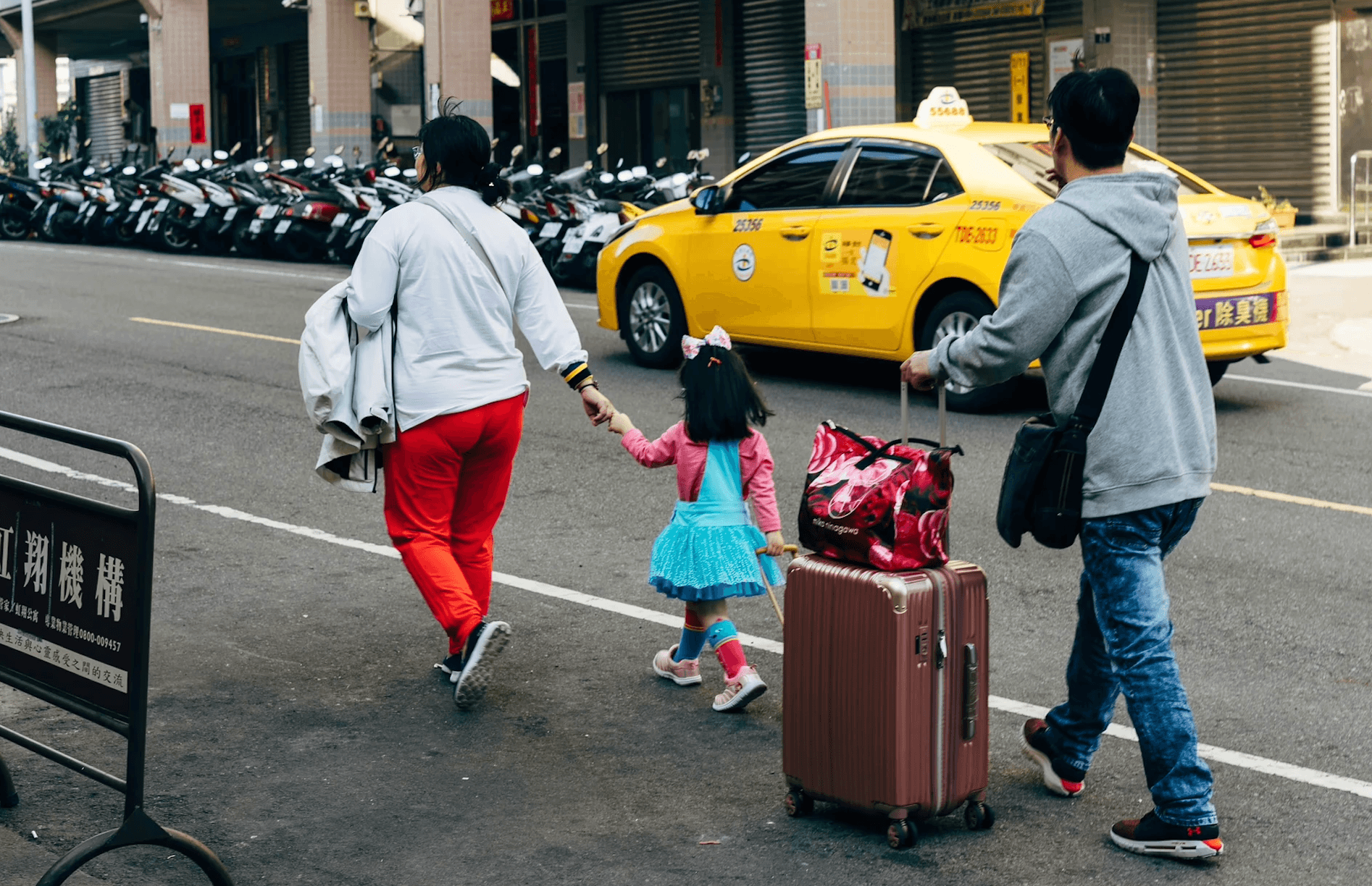 tourist family walking down street in asia