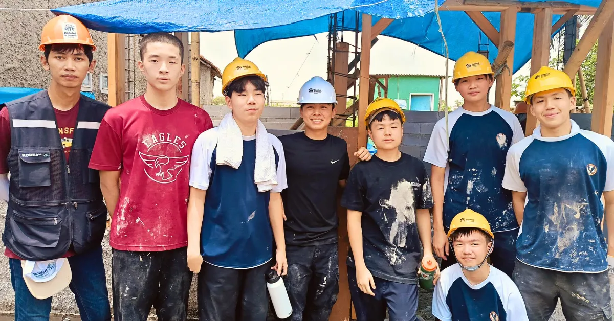 woman carrying white and green textbook