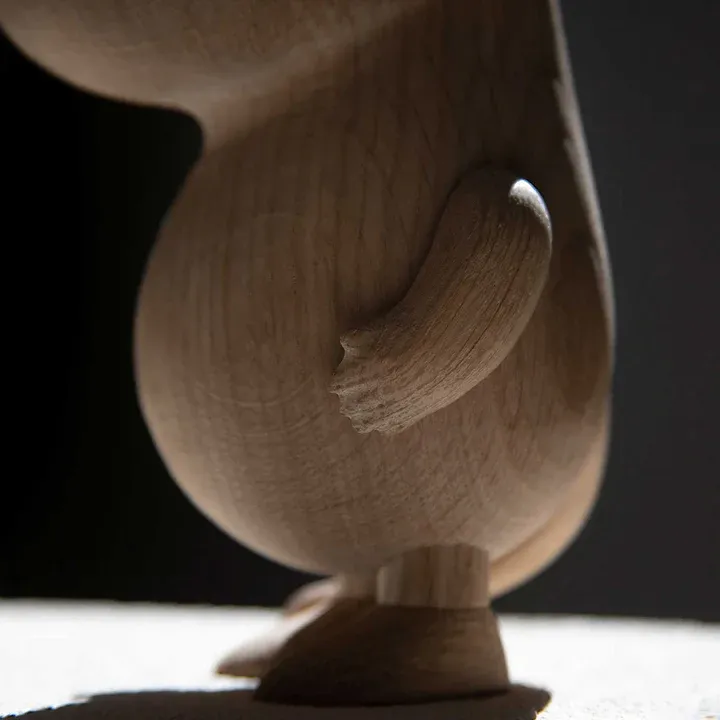 Close-up of GLOBAL cherry wood chopping board handle showing stainless steel detail and wood finish