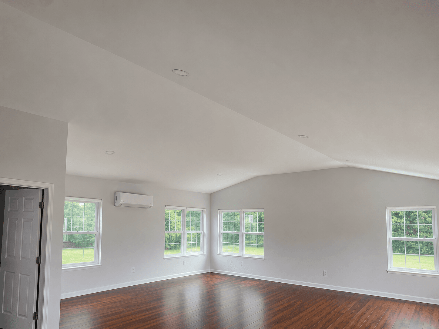 Completed interior living space inside a custom home addition with recessed lighting and finished flooring in Mount Airy NC.