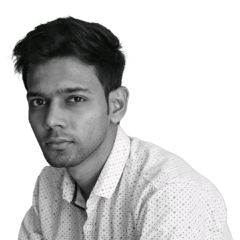 woman in blue denim jacket and white skirt standing beside brown wooden table