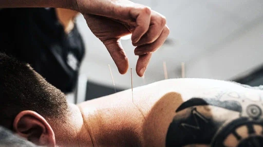 physiotherapist performing joint mobilization on patient’s shoulder