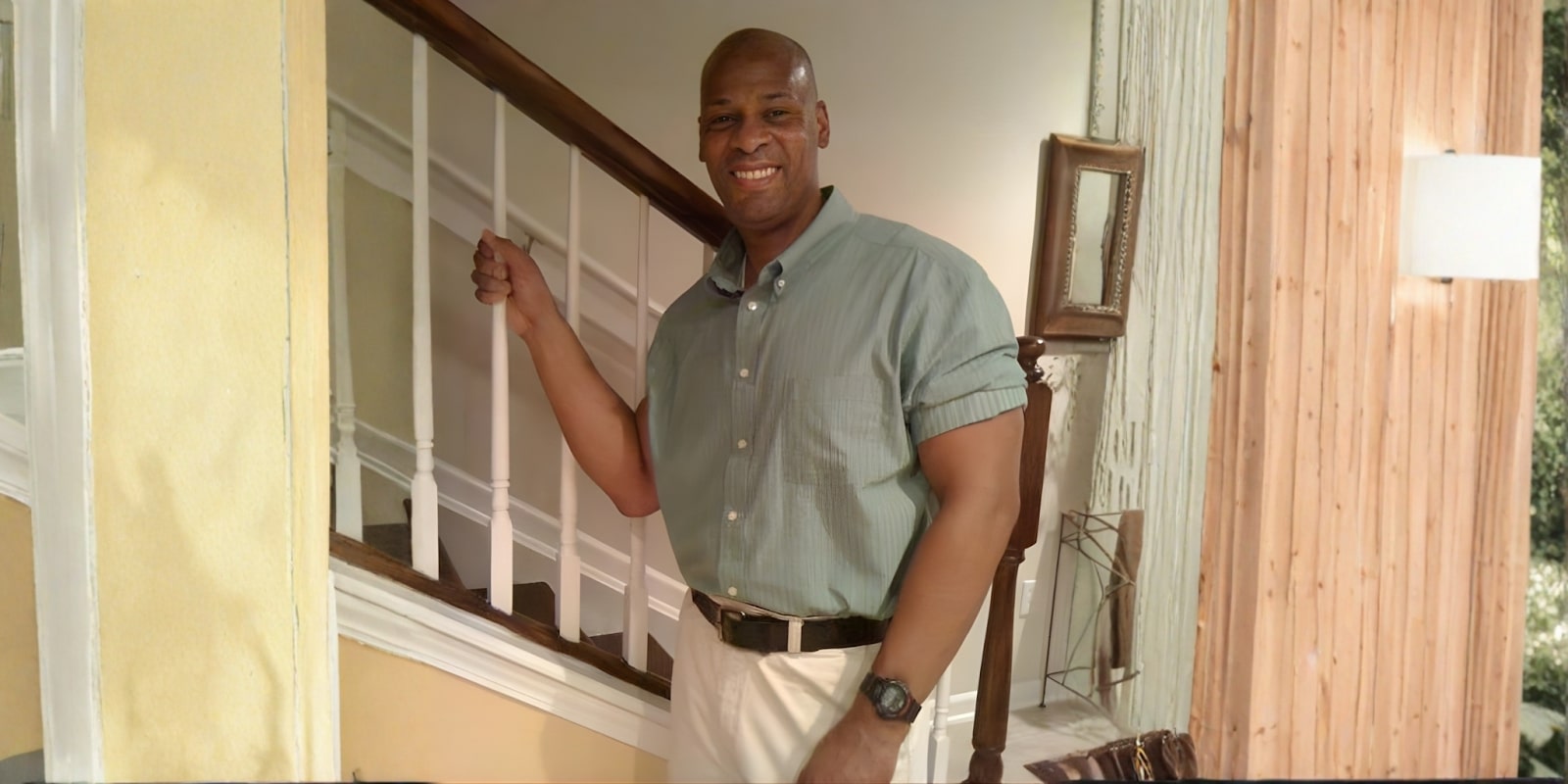 Errol Sanders smiling in a casual shirt, standing by a staircase, promoting Kingdom Law Enforcement seminar on combating violence.